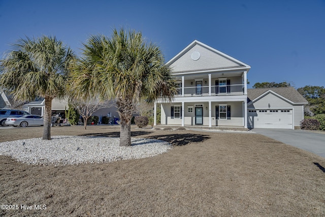 view of front of property with a balcony, a porch, and a garage