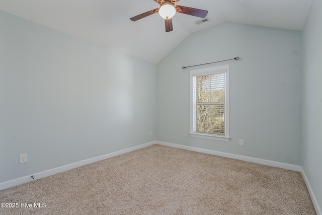 carpeted spare room with vaulted ceiling and ceiling fan