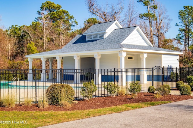 view of front of home featuring a fenced in pool