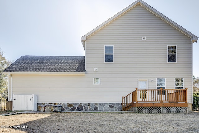 view of side of home featuring a wooden deck