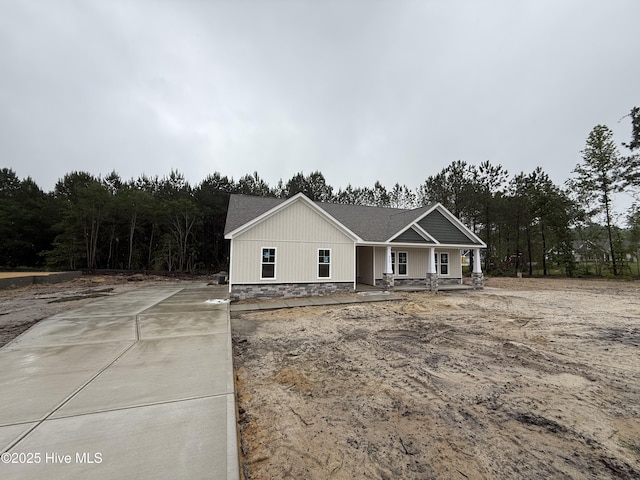 view of front of property with a porch and concrete driveway