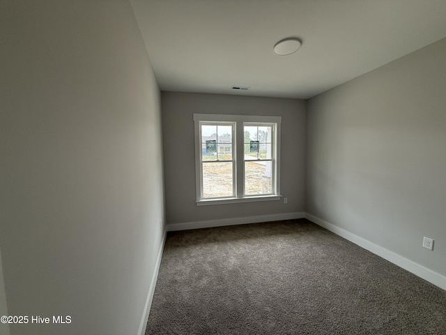 carpeted spare room with baseboards