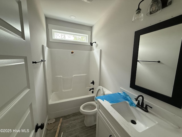 full bathroom with toilet, bathing tub / shower combination, vanity, and wood finished floors