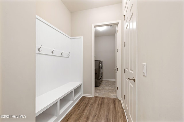 mudroom with washing machine and dryer and hardwood / wood-style flooring