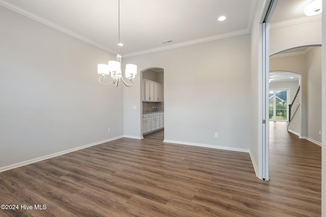 interior space featuring dark hardwood / wood-style floors, an inviting chandelier, and crown molding