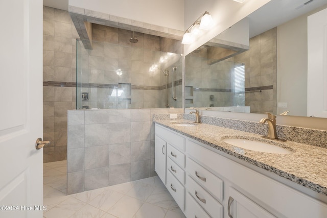 bathroom featuring a tile shower and vanity