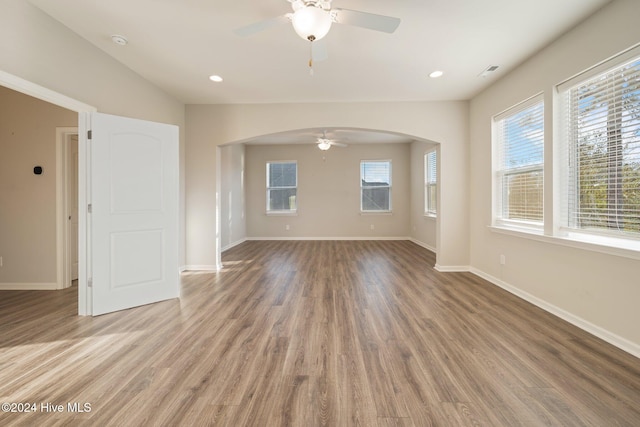 unfurnished living room with ceiling fan and wood-type flooring