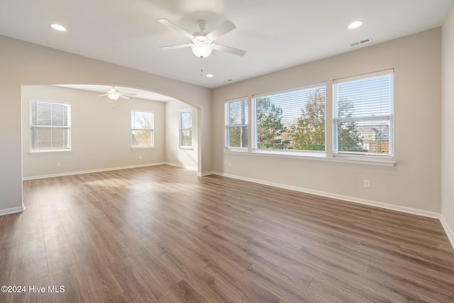 empty room featuring ceiling fan and dark wood-type flooring