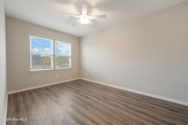 spare room featuring ceiling fan and dark hardwood / wood-style floors