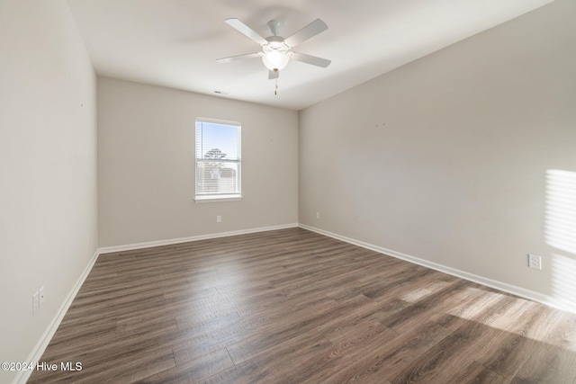 unfurnished room with dark hardwood / wood-style floors and ceiling fan