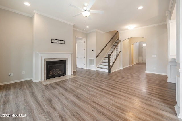 unfurnished living room with crown molding, ceiling fan, and light hardwood / wood-style floors