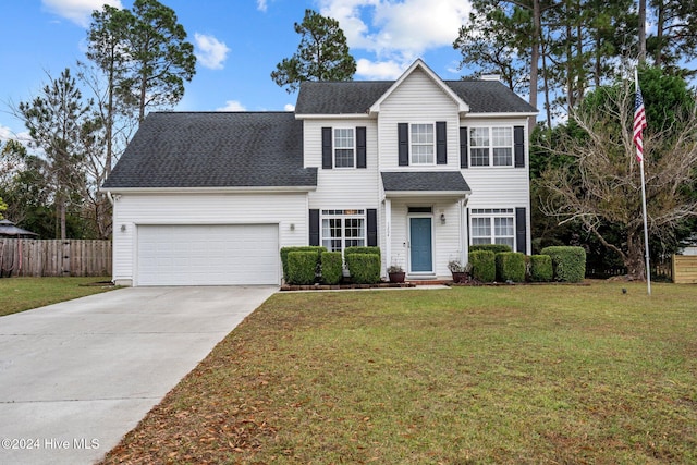 view of front of property with a garage and a front lawn