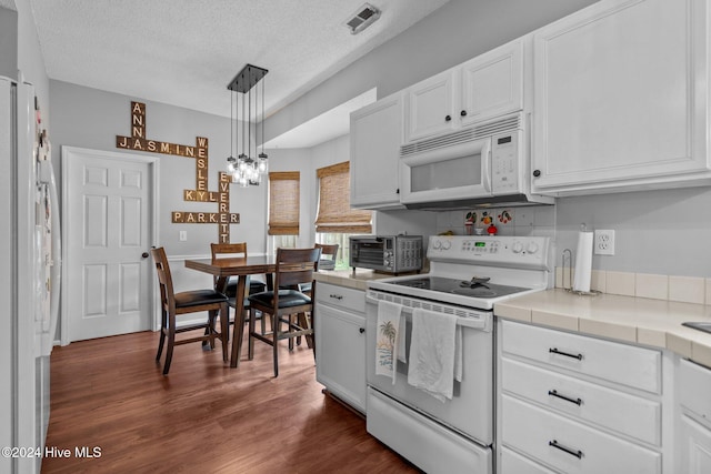 kitchen featuring pendant lighting, white appliances, dark wood-type flooring, a textured ceiling, and white cabinetry