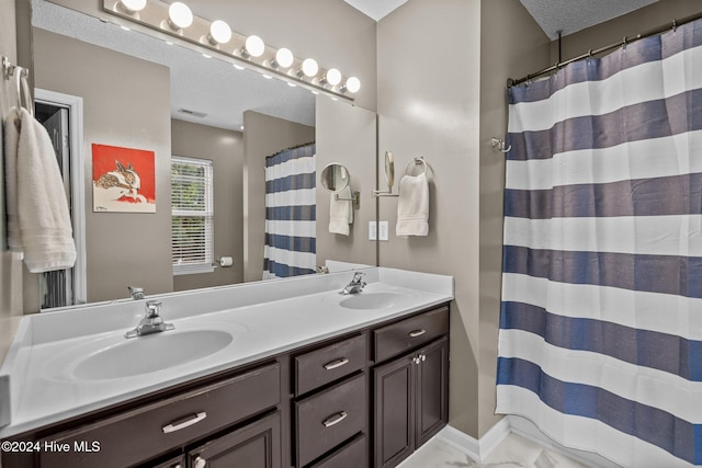 bathroom with vanity and a textured ceiling