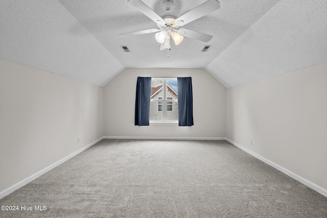 bonus room with ceiling fan, lofted ceiling, a textured ceiling, and carpet floors