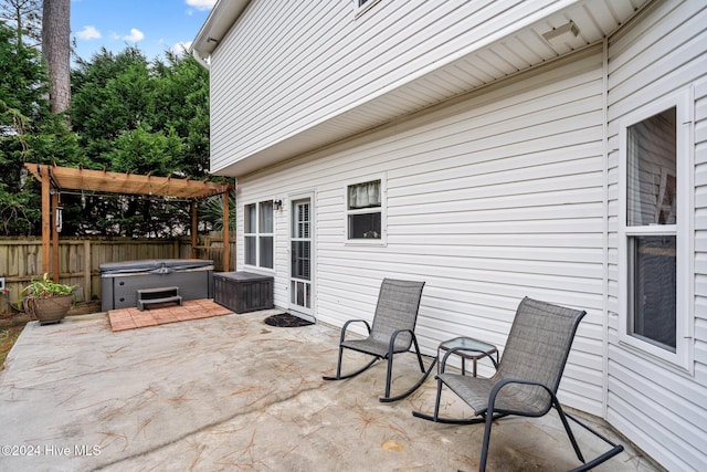 view of patio / terrace with a pergola and a hot tub