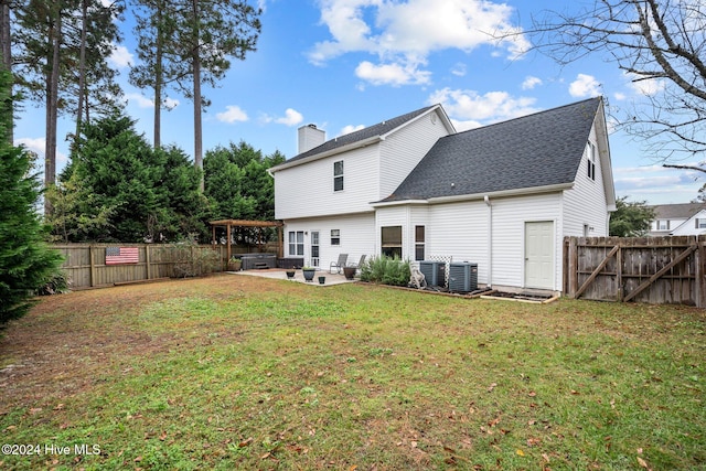 back of property with a yard and a patio