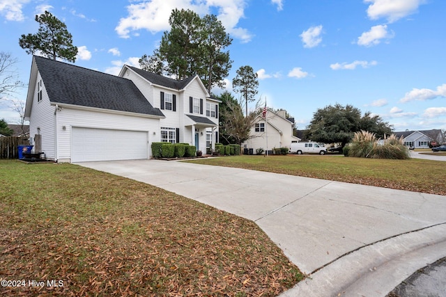 view of property featuring a front yard and a garage