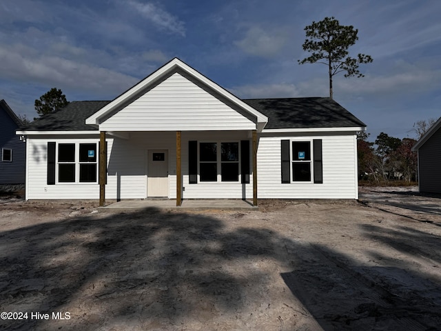 view of front facade with roof with shingles