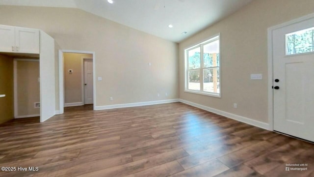 entryway with vaulted ceiling, recessed lighting, wood finished floors, and baseboards