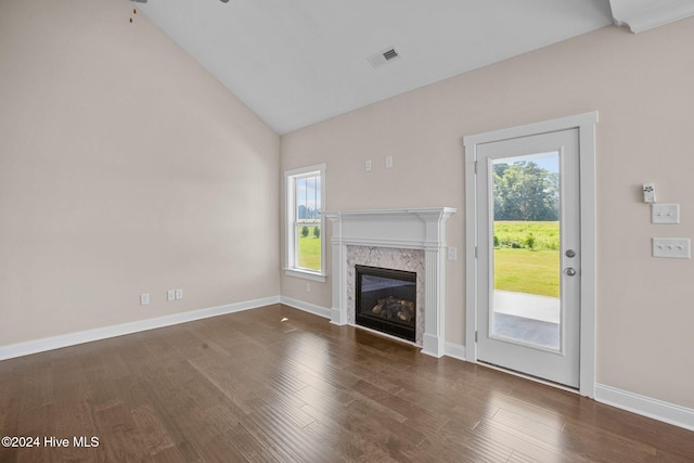 unfurnished living room with a fireplace, dark hardwood / wood-style flooring, and high vaulted ceiling