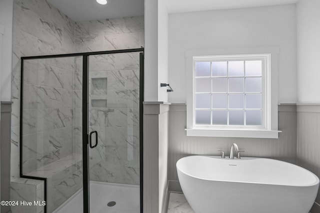 bathroom featuring separate shower and tub