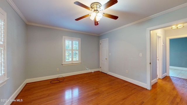 empty room featuring light hardwood / wood-style flooring, ceiling fan, and crown molding