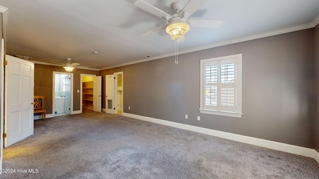 carpeted spare room with ceiling fan and crown molding