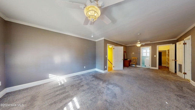 carpeted spare room featuring ceiling fan and crown molding