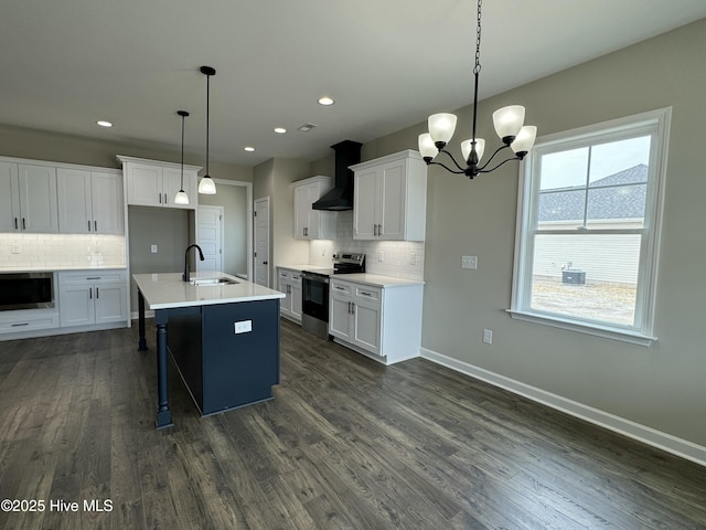 kitchen with dark wood-style floors, baseboards, electric stove, stainless steel microwave, and wall chimney range hood