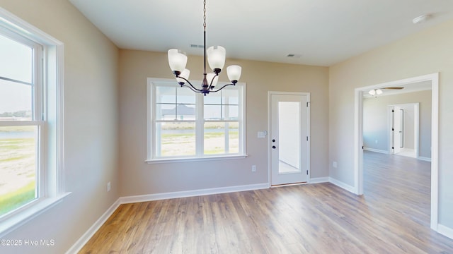 1407 Stoney Creek Church Rd, Goldsboro, NC 27534 - unfurnished dining area with light wood finished floors, a chandelier, and baseboards