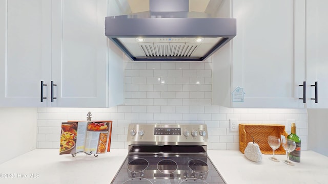 1407 Stoney Creek Church Rd, Goldsboro, NC 27534 - kitchen featuring wall chimney exhaust hood, stainless steel electric range, tasteful backsplash, light countertops, and white cabinets