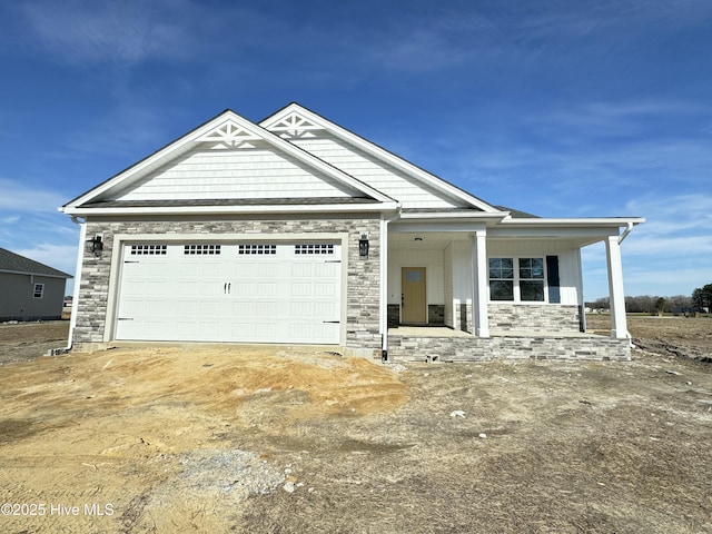 craftsman inspired home with a garage and a porch