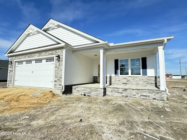 view of front facade with covered porch and a garage