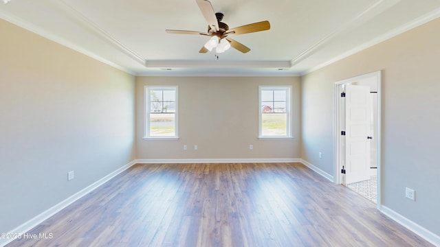1407 Stoney Creek Church Rd, Goldsboro, NC 27534 - empty room with a raised ceiling, plenty of natural light, ornamental molding, wood finished floors, and ceiling fan