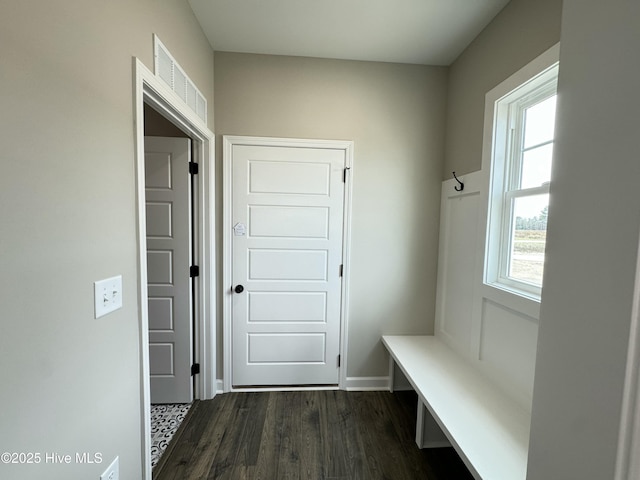 mudroom featuring visible vents, baseboards, and dark wood finished floors