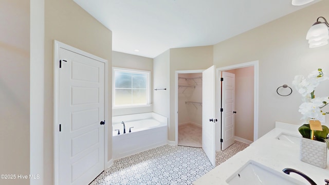1407 Stoney Creek Church Rd, Goldsboro, NC 27534 - full bath with a bath, baseboards, double vanity, a spacious closet, and speckled floor