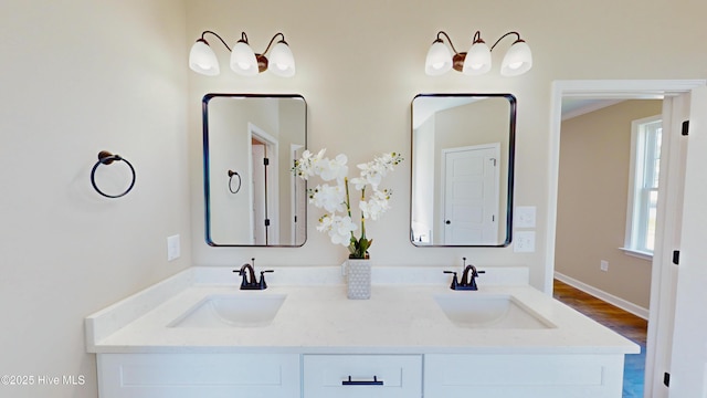 1407 Stoney Creek Church Rd, Goldsboro, NC 27534 - bathroom with double vanity, wood finished floors, and baseboards