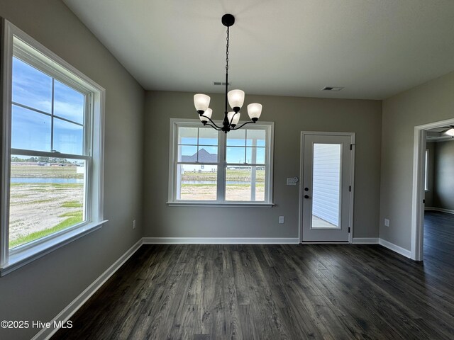 spare room with crown molding, dark wood-type flooring, a raised ceiling, and ceiling fan