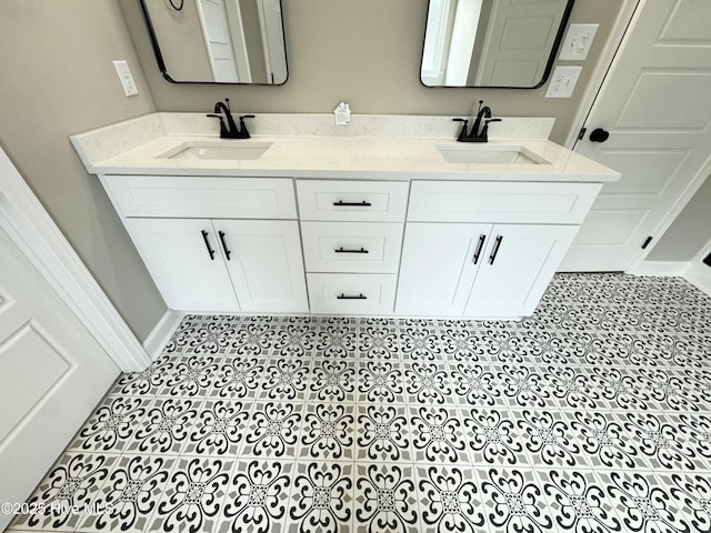 bathroom featuring double vanity, baseboards, and a sink