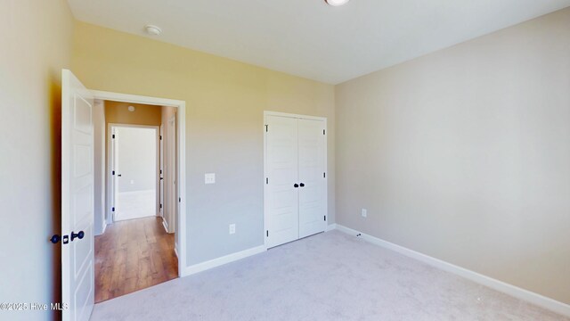 1407 Stoney Creek Church Rd, Goldsboro, NC 27534 - unfurnished bedroom with carpet flooring, baseboards, and a closet