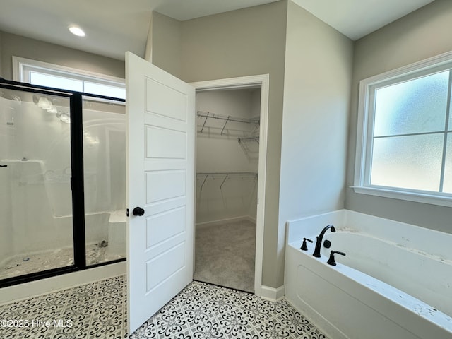 bathroom featuring shower with separate bathtub