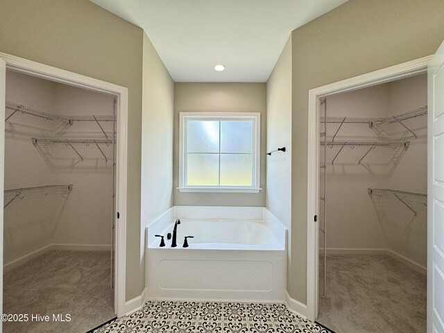 full bath featuring tile patterned flooring, shower / washtub combination, toilet, and vanity