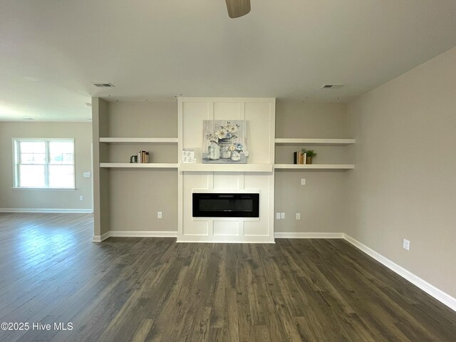 unfurnished living room with dark wood-type flooring and ceiling fan