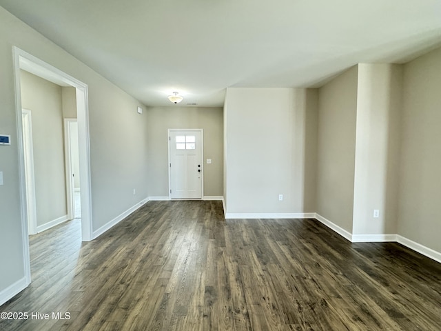 entrance foyer featuring baseboards and dark wood-style flooring