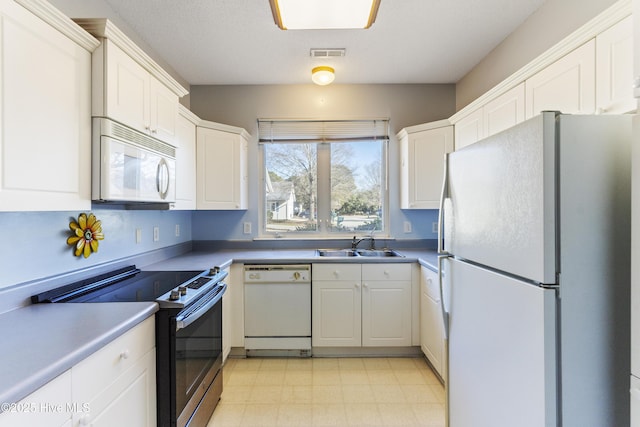 kitchen featuring white cabinets, sink, and appliances with stainless steel finishes