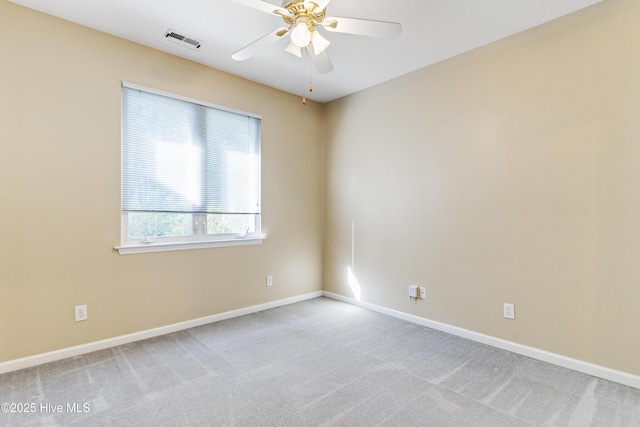 carpeted spare room with ceiling fan