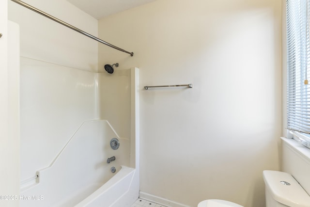 bathroom featuring shower / bath combination and toilet