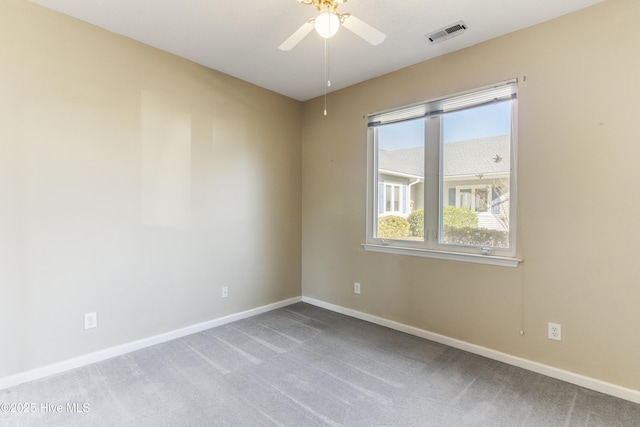 carpeted empty room featuring ceiling fan