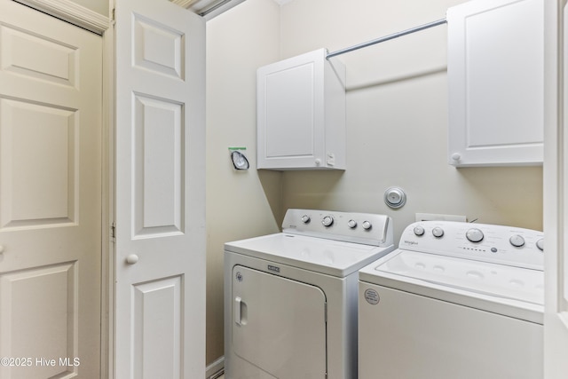 washroom featuring cabinets and separate washer and dryer